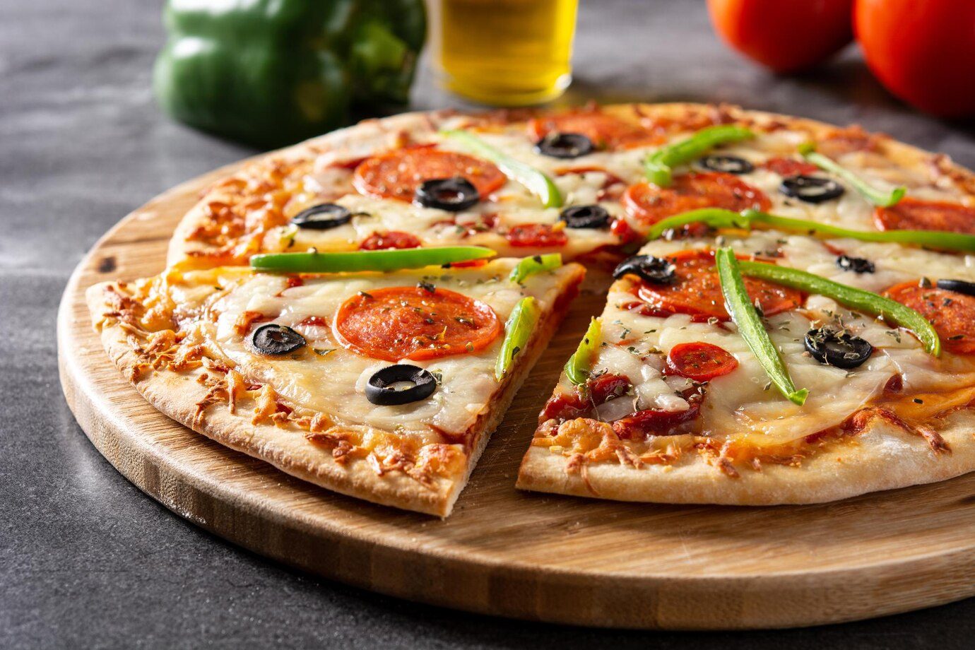 Traditional supreme pizza on black stone Traditional supreme pizza on black stone